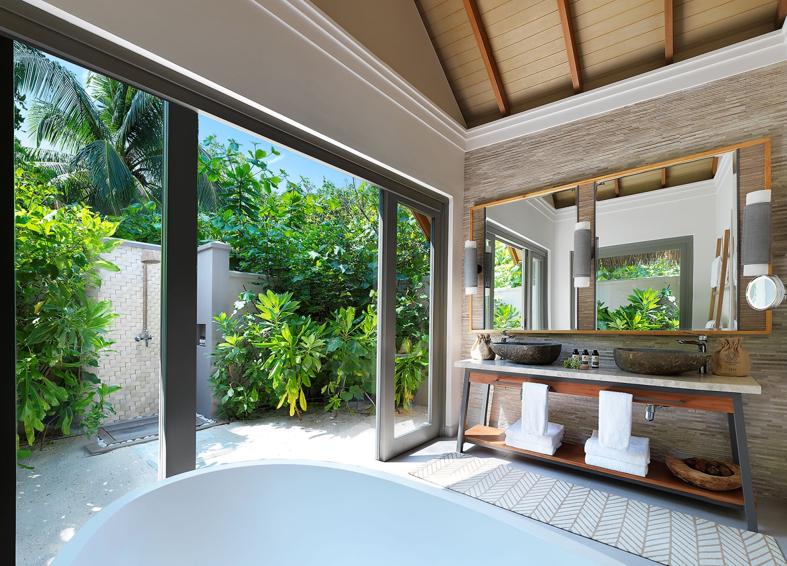 Bathroom in the beach bungalow with an outdoor shower 