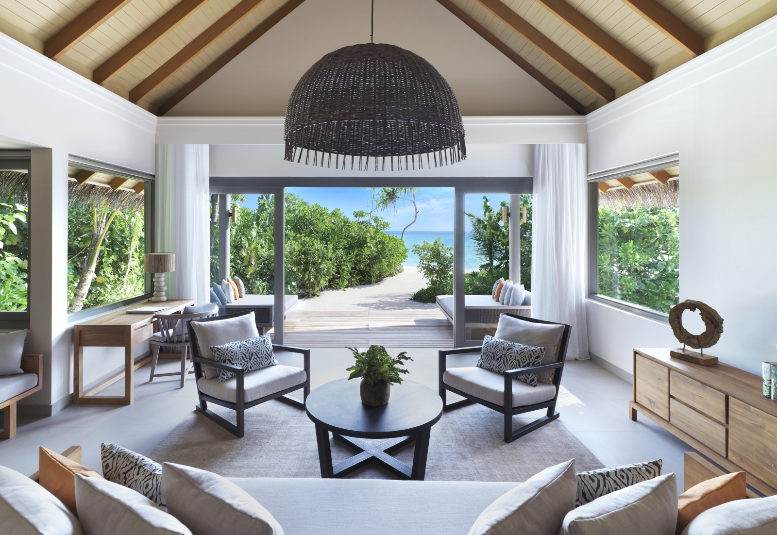 Living room at deluxe beach pool suite with views out to the ocean