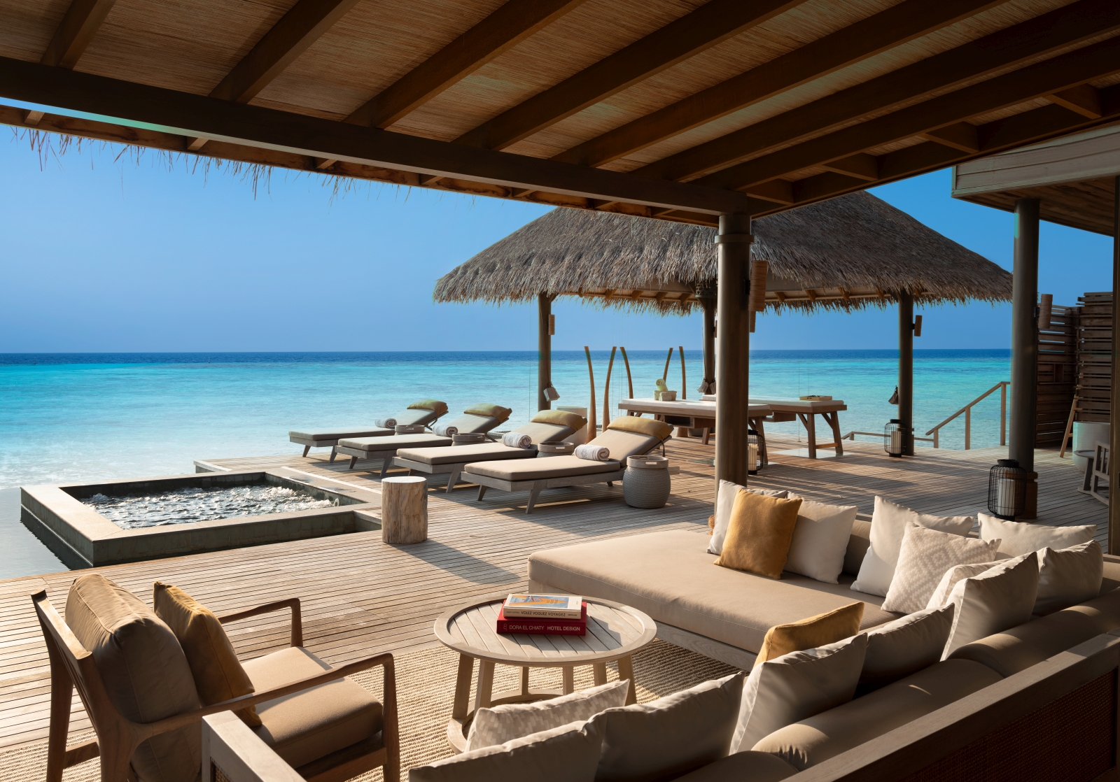 Terrace with seating, loungers and private plunge pool of a four-bedroom villa at luxury resort Vakkaru in the Maldives