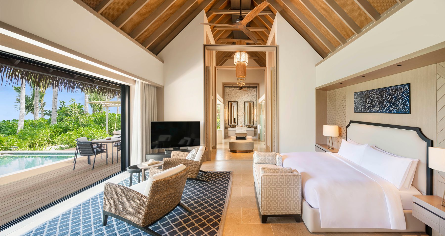 Beach villa bedroom with pool view at Waldorf Astoria Maldives Ithaafushi