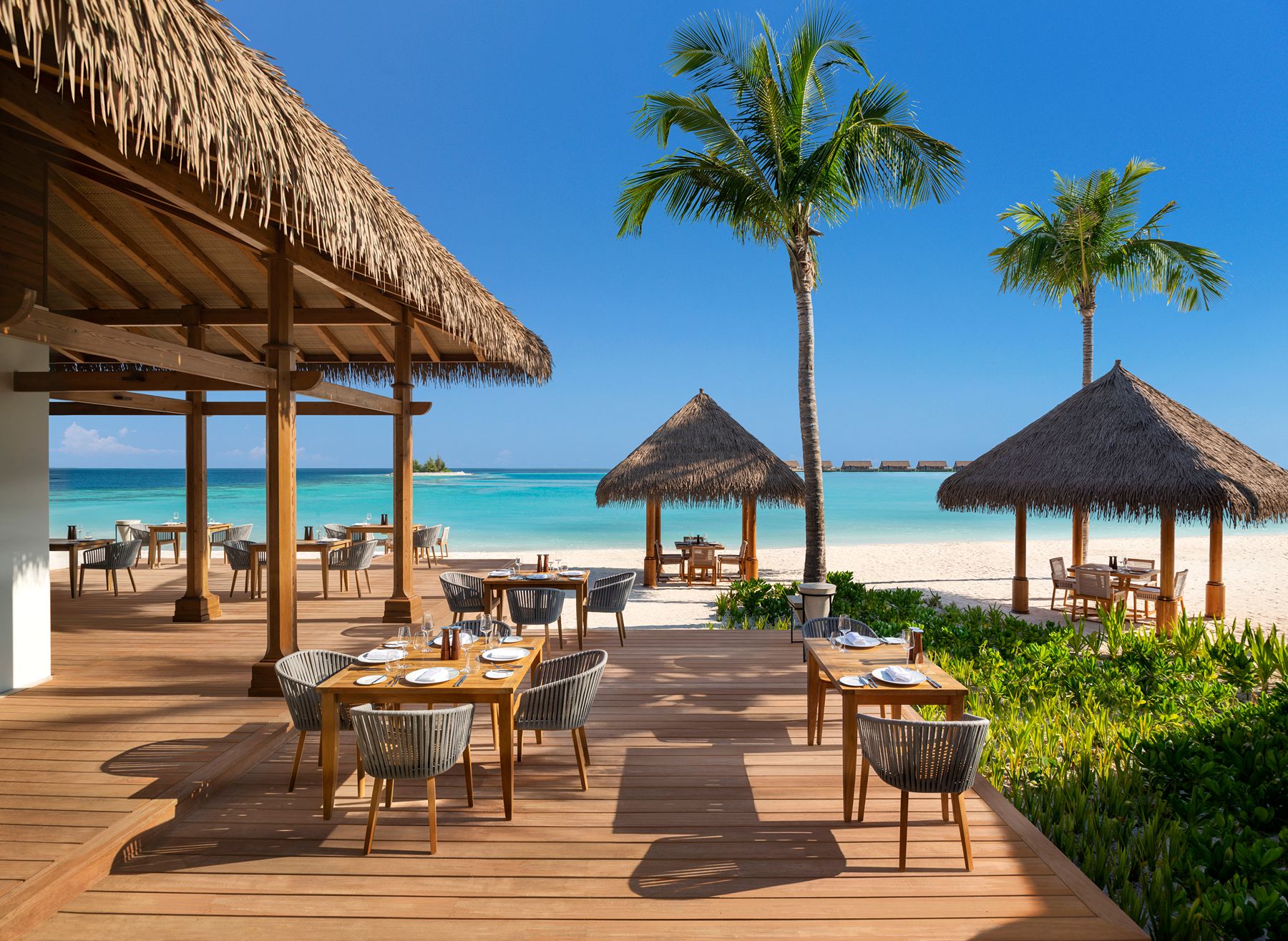 Tasting table deck with beach views at Waldorf Astoria Maldives Ithaafushi