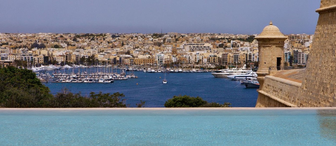 Bastion and harbour views from the infinity pool at The Phoenica Malta hotel in Valletta