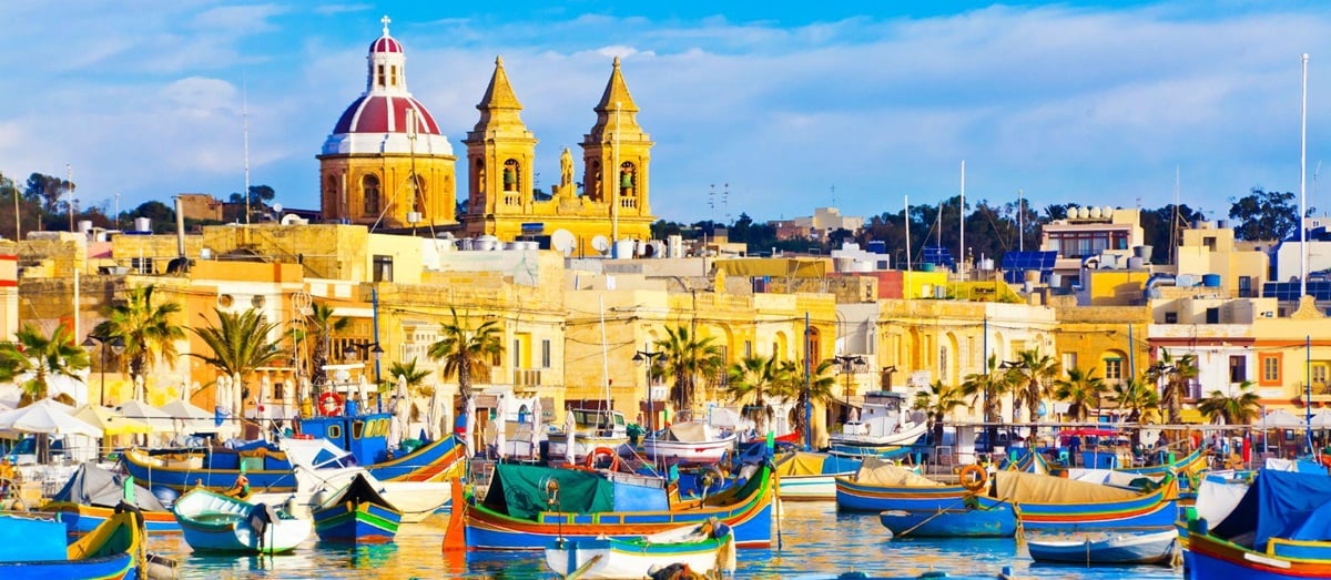 Marsaxlokk harbour in Malta with colourful fishing boats