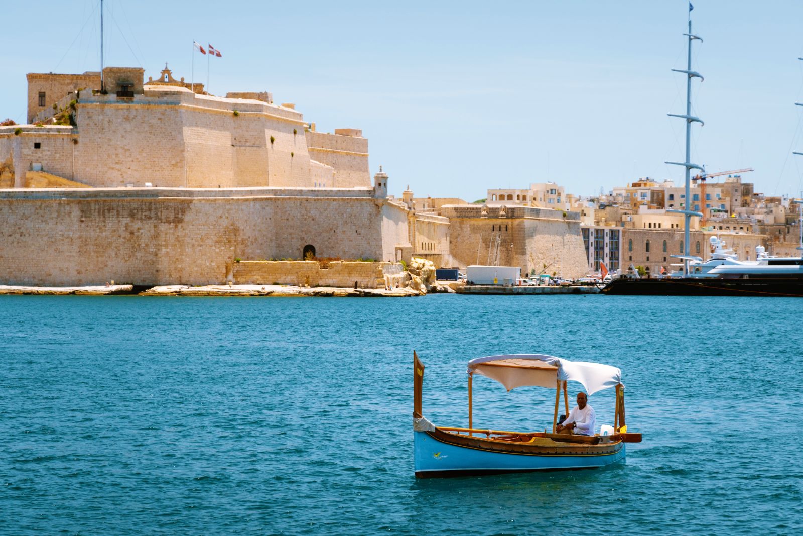 A small wooden boat in the harbour near Valletta in Malta