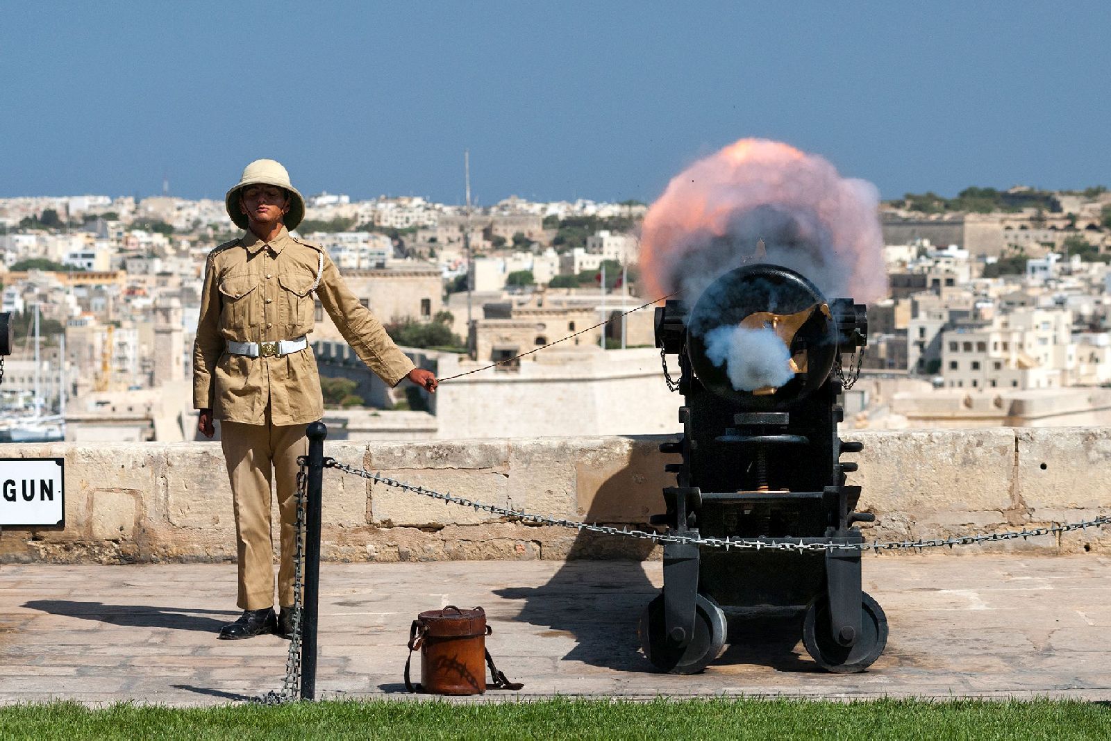 Soldier and cannon fire at Battery Salute in Valletta, Malta