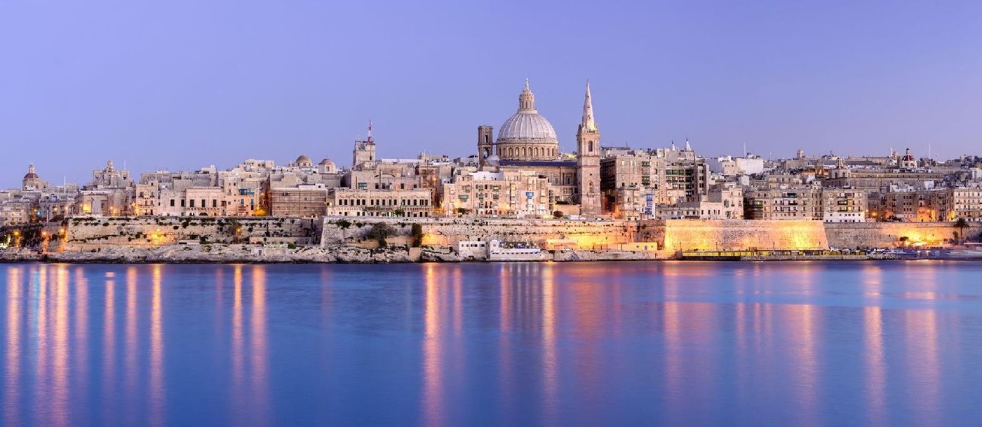 Panorama of Valletta city and coastline in Malta illuminated at dusk