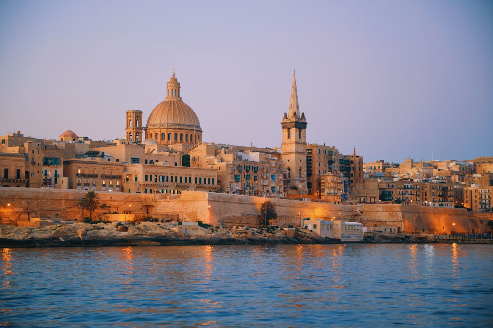 A waterfront near Valletta in Malta illuminated at dusk