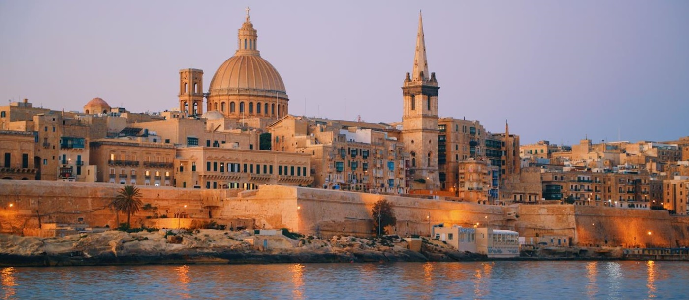 A waterfront near Valletta in Malta illuminated at dusk