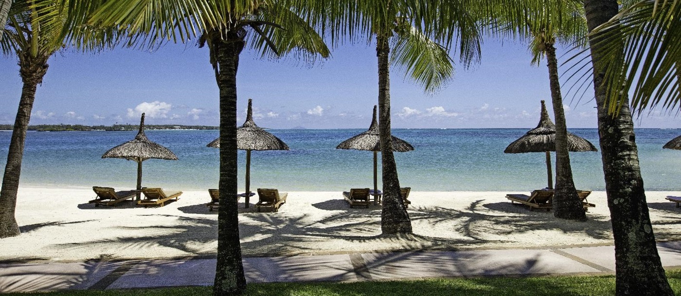 beachfront and parasols at COMO Le Saint Geran, Mauritius