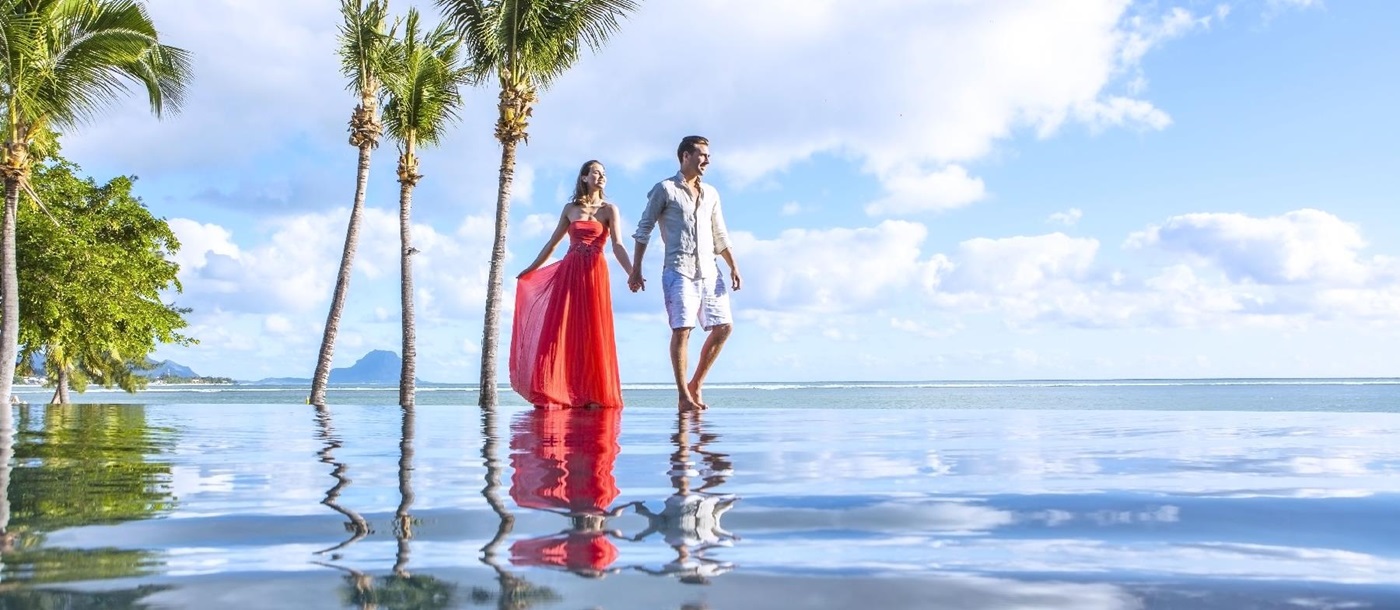 reflection of a couple in the infinity pool at Maradiva Resort, mauritius