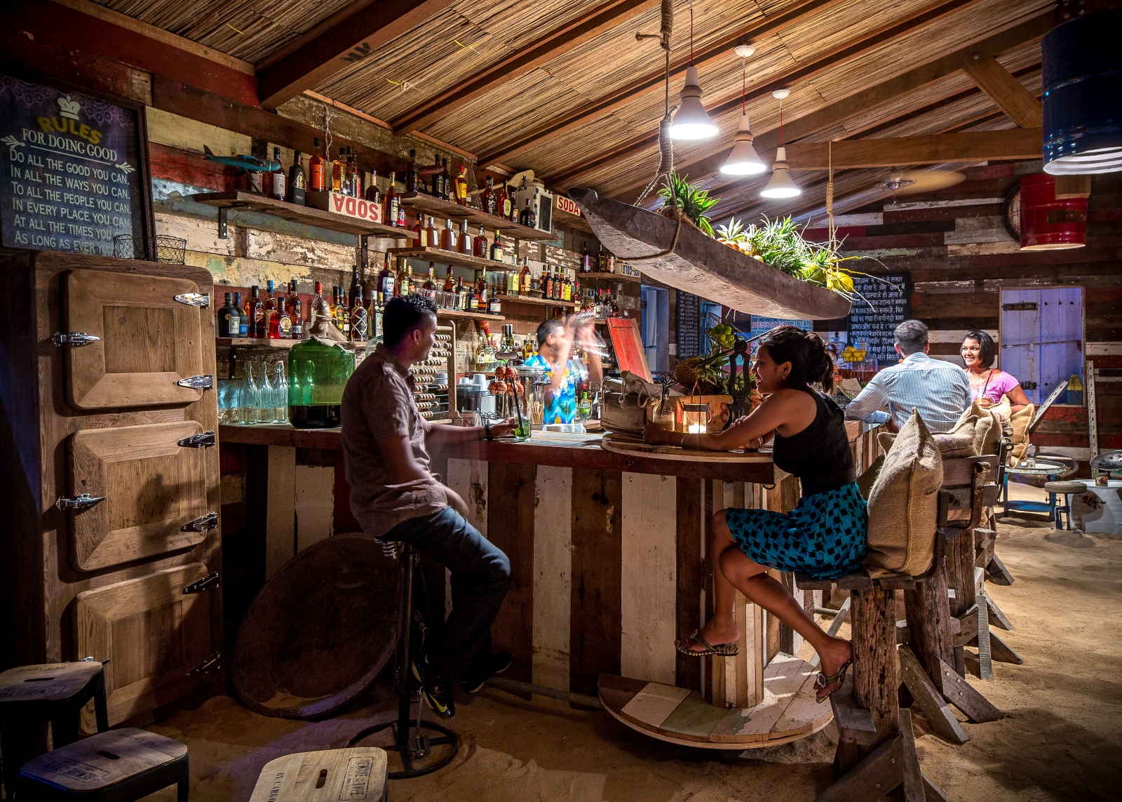 People enjoying drinks at the bar of the Rum Shed