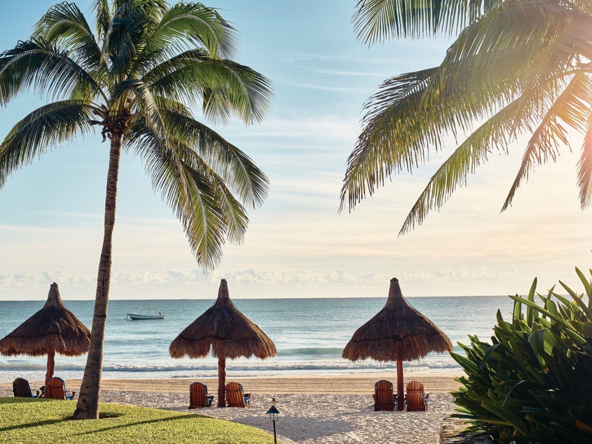 Loungers on the palm fringed beach at Belmond Maroma in Mexico
