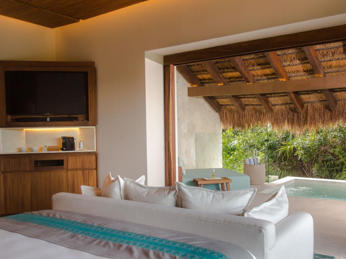 Bedroom and pool view in a villa at Chabla Maroma on the Yucatan Peninsula in Mexico