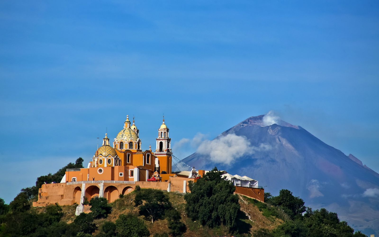 Cholula sitting in front of the Popocatépetl Volcano in Mexico