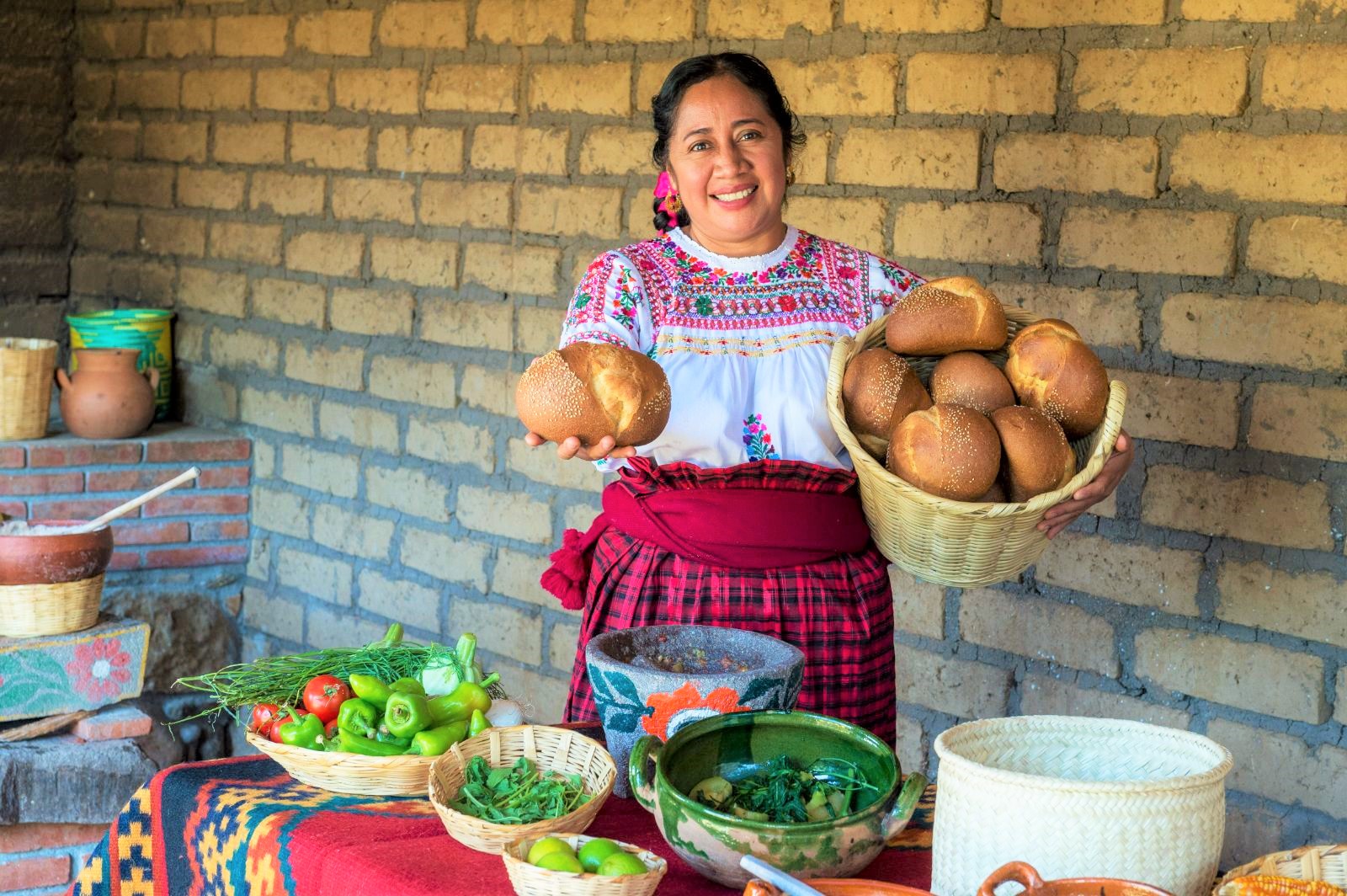 A Mexican woman with a selection of local produce