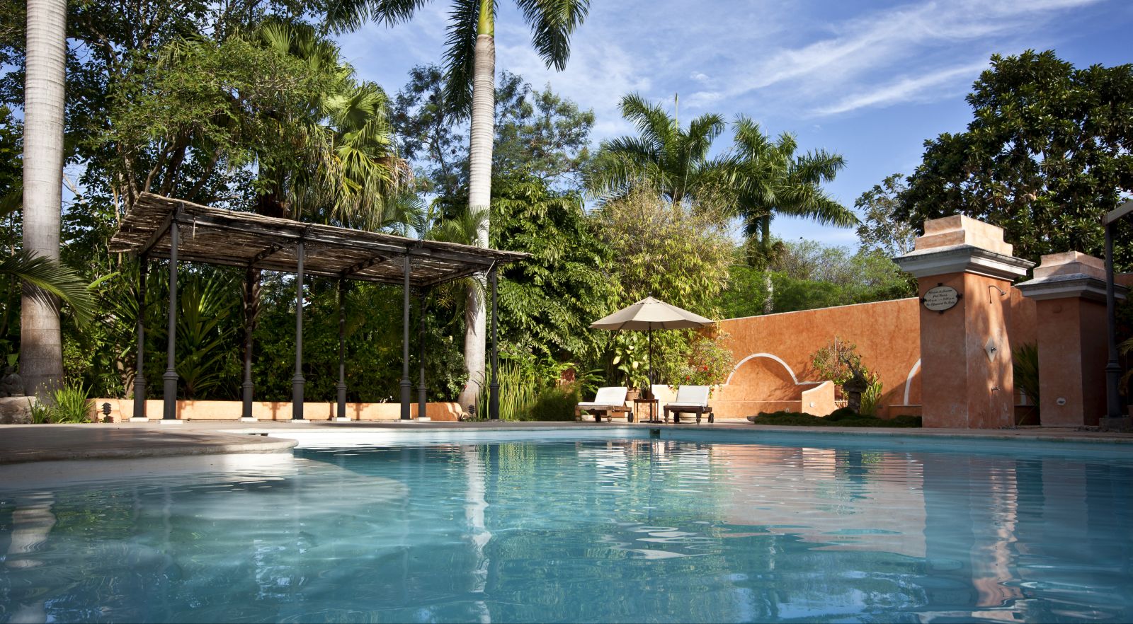 A view across the pool at the small luxury hotel Hacienda Xcanatun in Mexico
