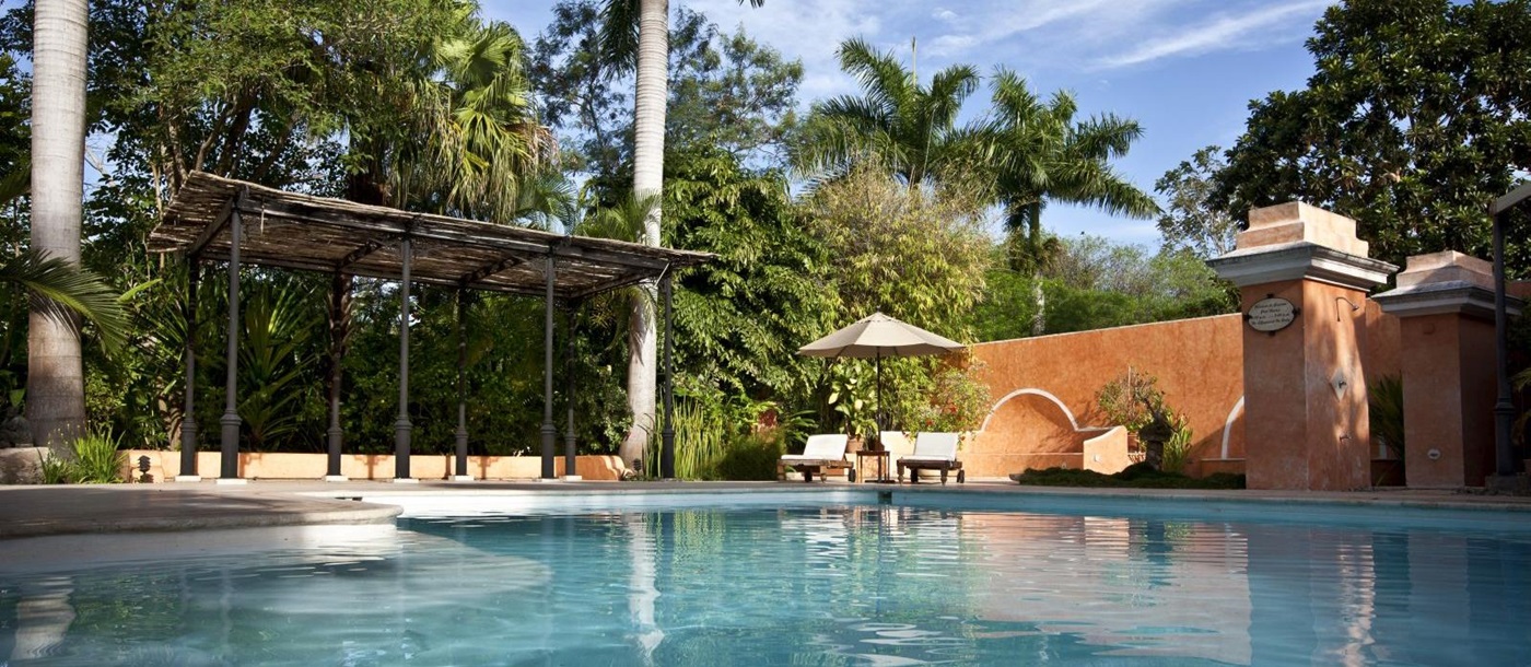 A view across the pool at the small luxury hotel Hacienda Xcanatun in Mexico
