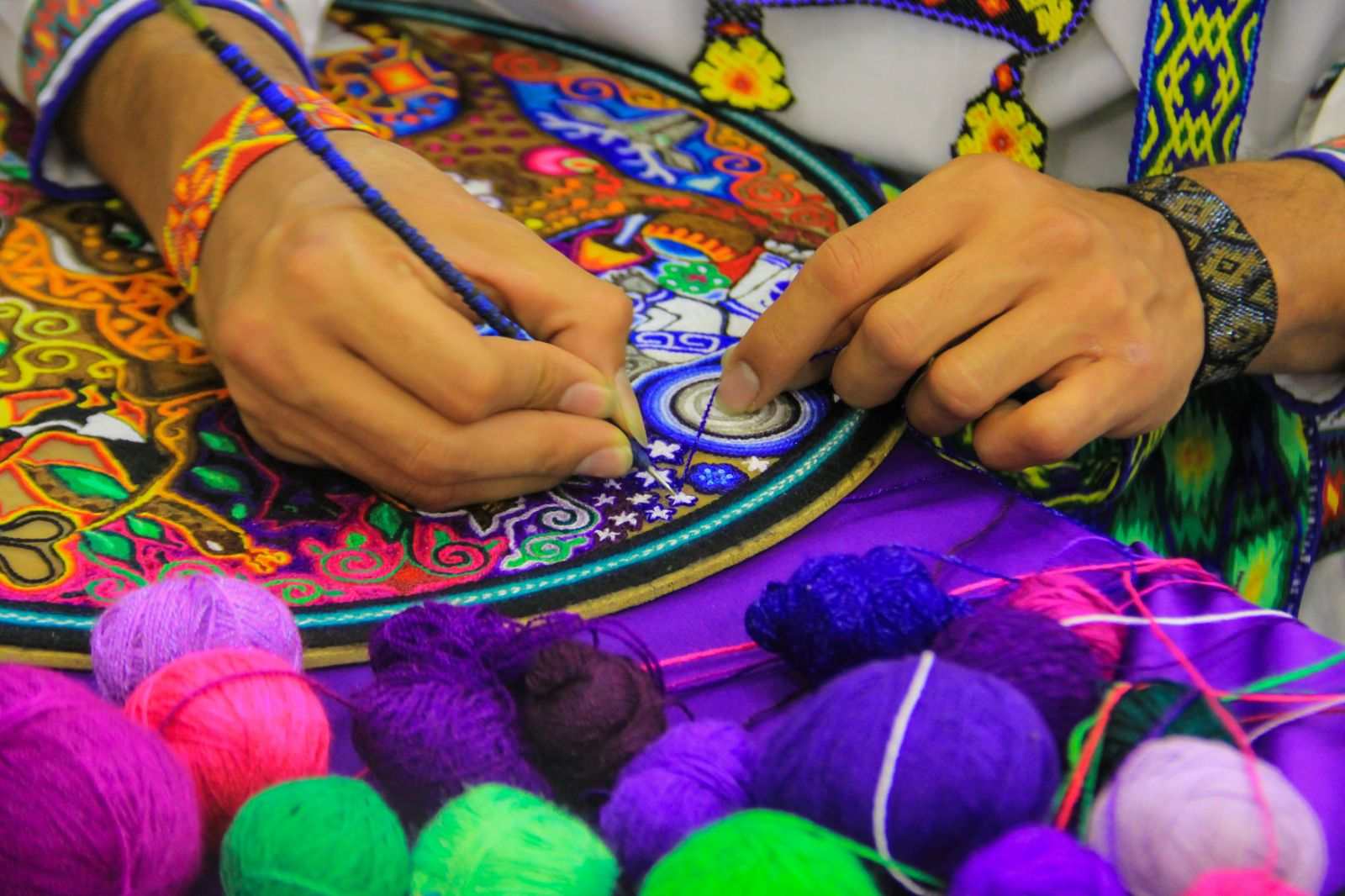 A woman doing traditional Mexican crafts