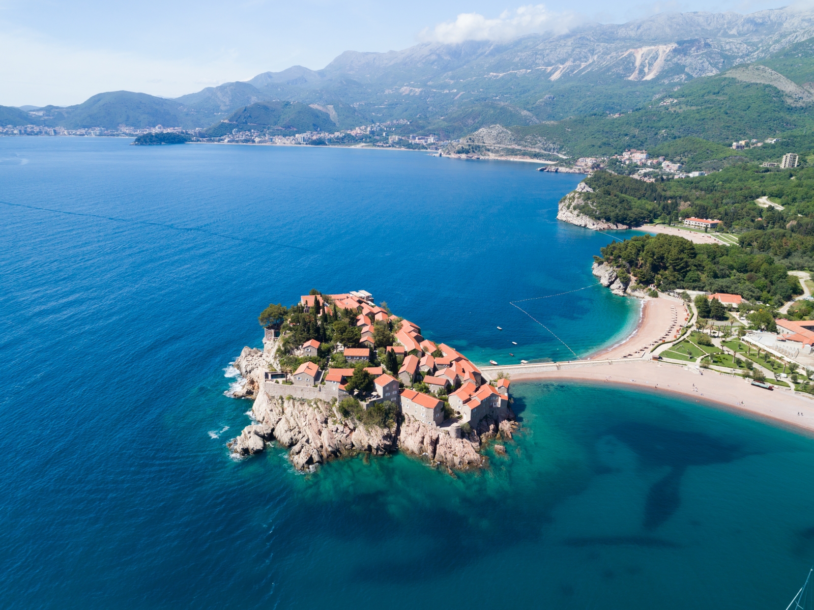 Aerial view of Sveti Stefan and its peninsula surrounded by the turquoise waters of the Mediterranean Sea