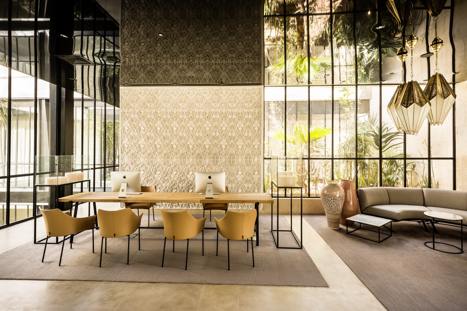 Stylish open workspace at Hotel Sahrai equipped with Mac Books