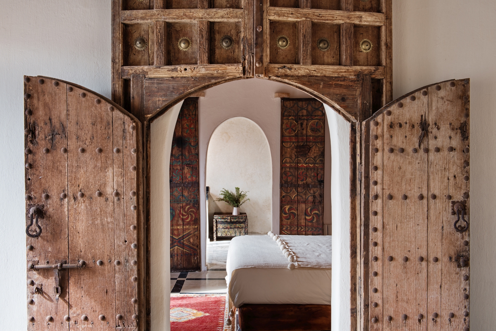 Artisically carved door frame leading to a bedroom