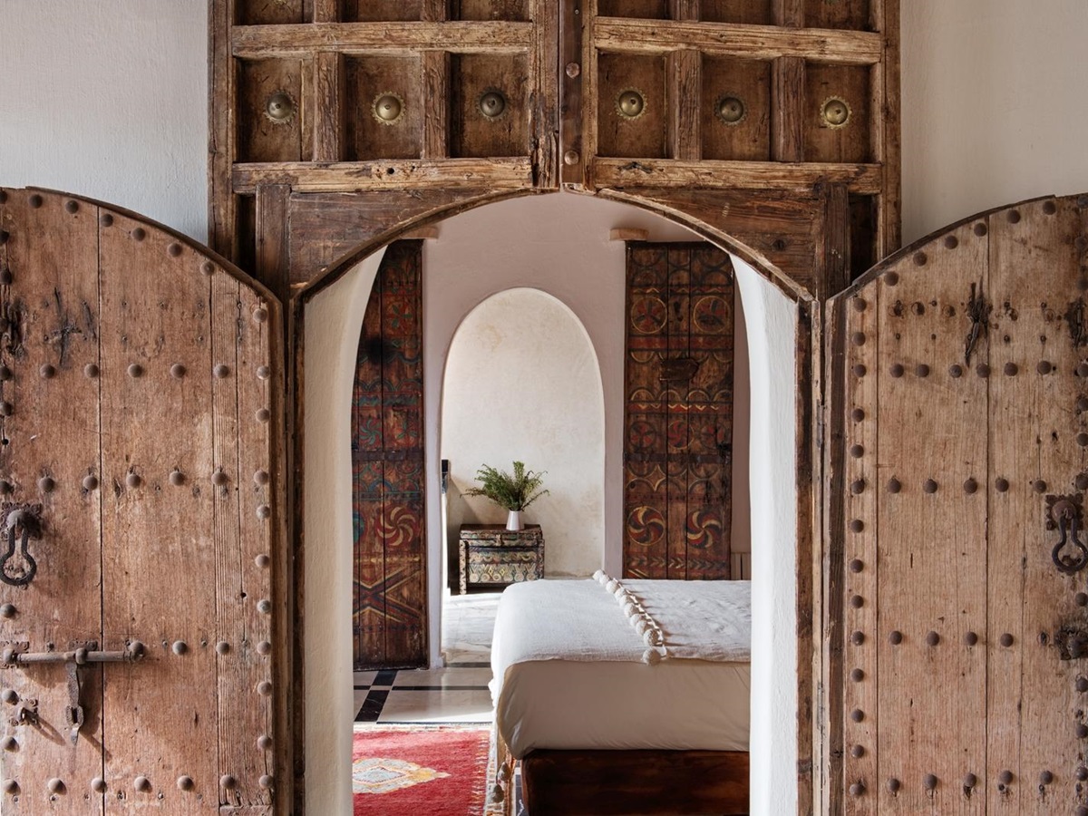 Artisically carved door frame leading to a bedroom