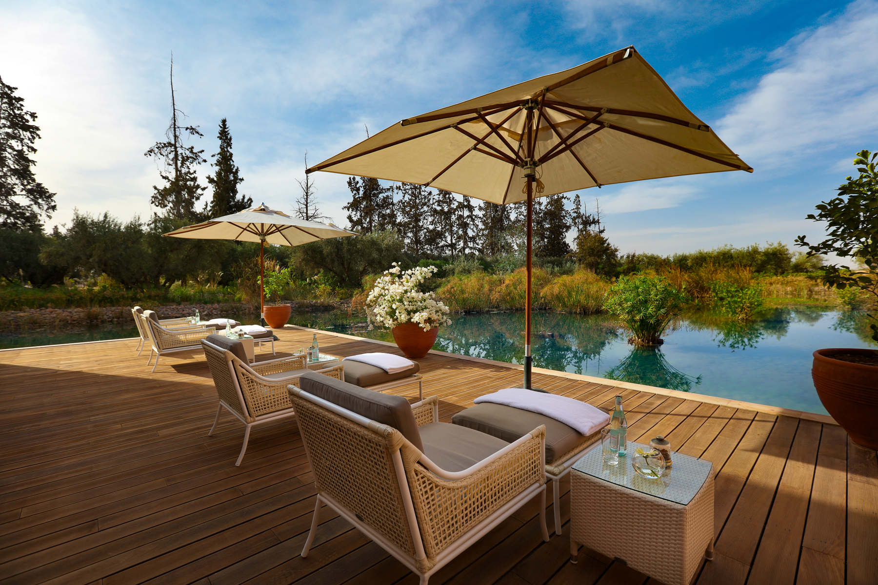 Outdoor relaxation area with pool and loungers at the Oberoi Marrakech hotel