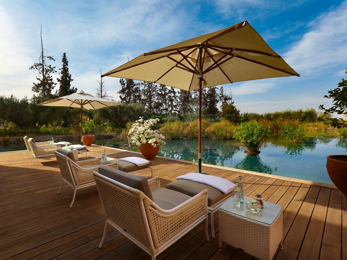 Outdoor relaxation area with pool and loungers at the Oberoi Marrakech hotel