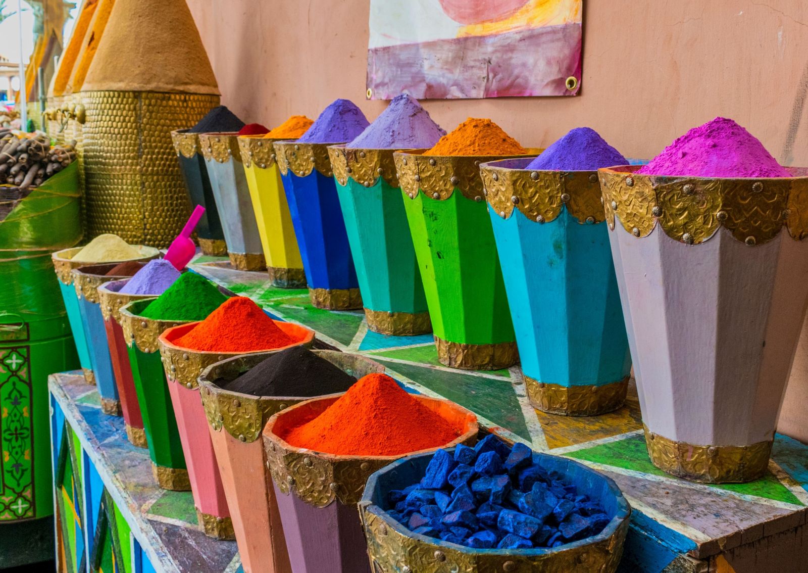Urns of brightly coloured dyes at a market in Morocco
