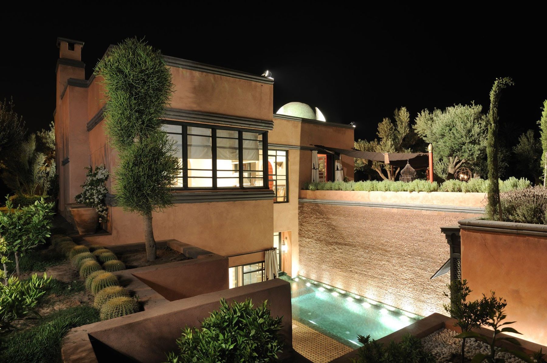 Pool and villa at night at Villa Alkhozama in Morocco