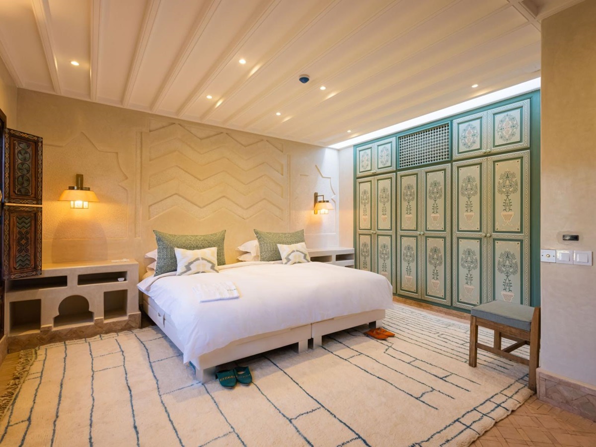 Green and white bedroom at Villa Azeer in Morocco