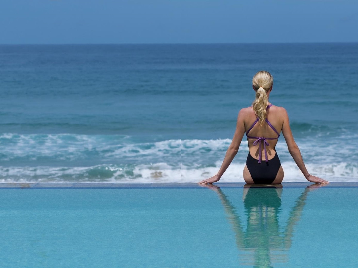 Reflection of a woman in the main pool of White Pearl, Mozambique