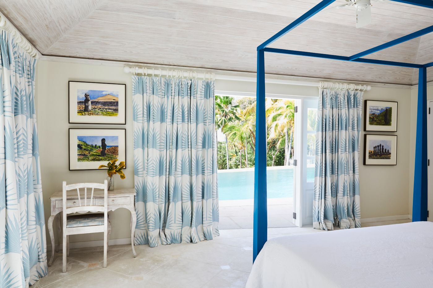 Bedroom at Bamboo House with four poster bed and view of the pool and gardens