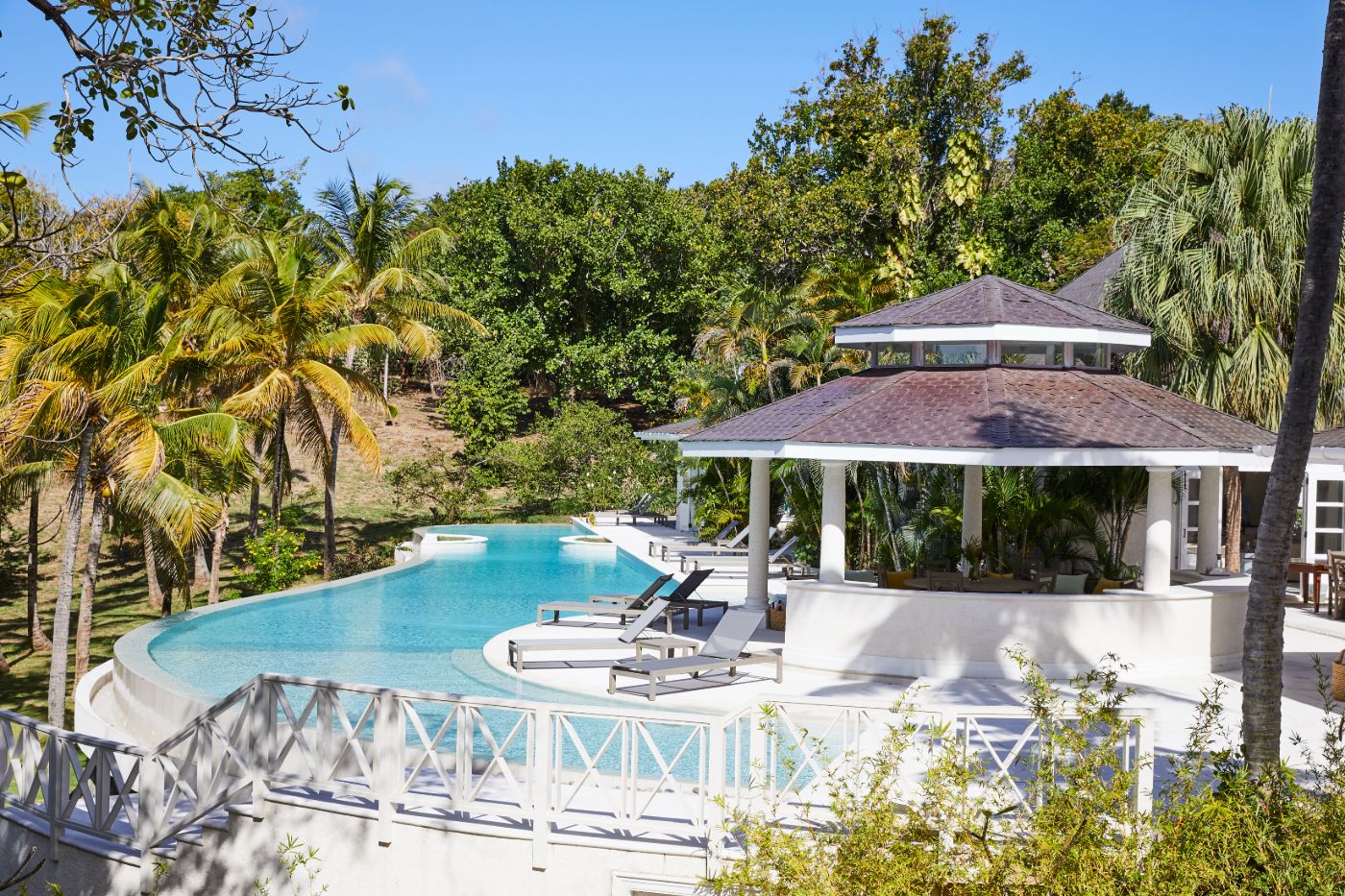 View of the pool, gardens and covered terrace at Bamboo House