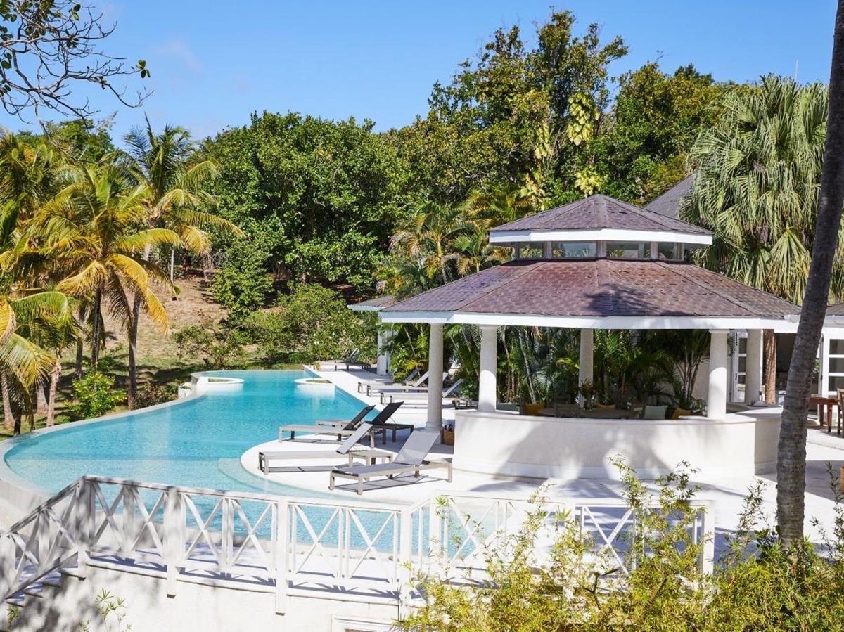 View of the pool, gardens and covered terrace at Bamboo House