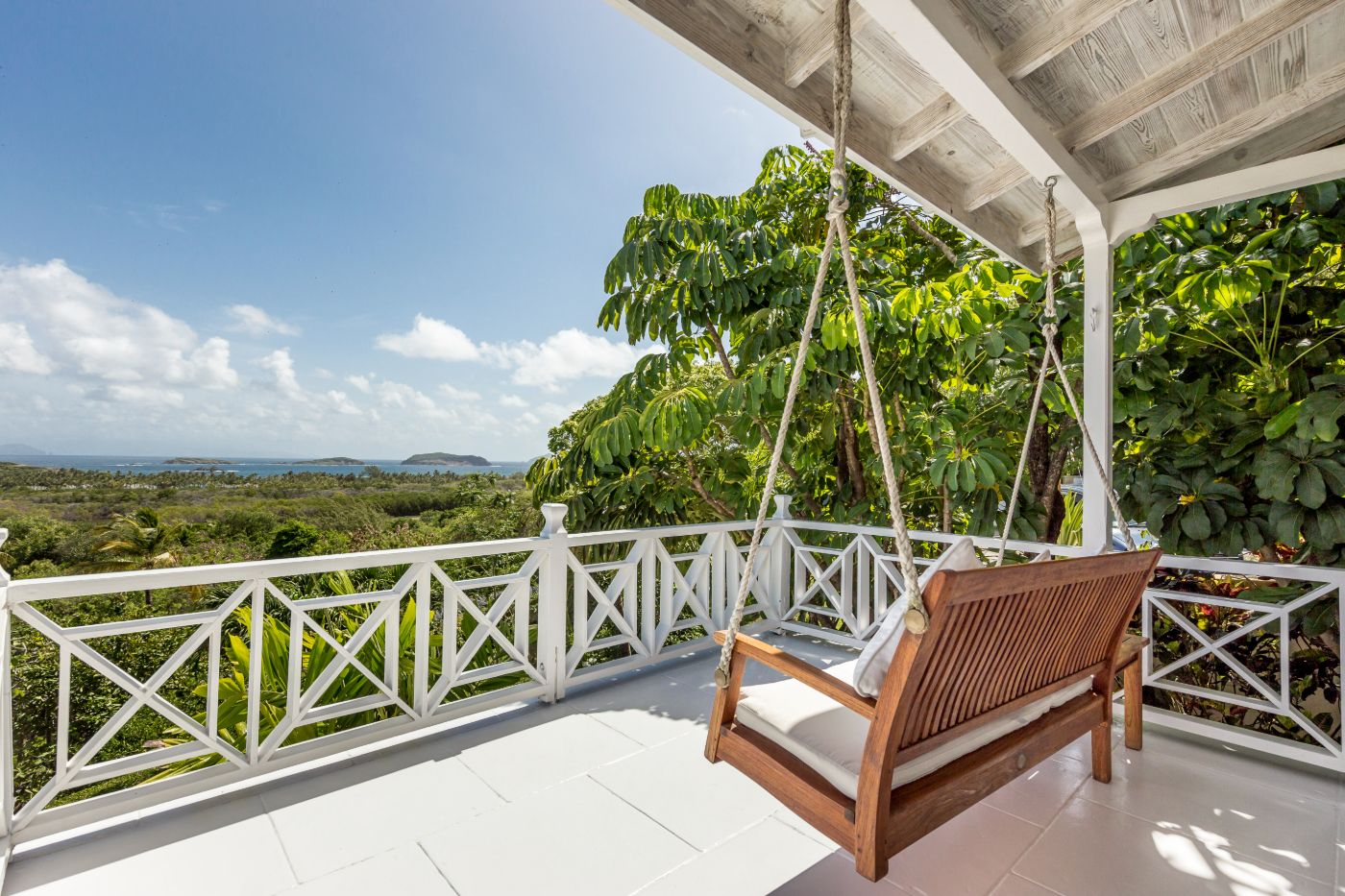 Balcony with sofa swing overlooking the countryside and coastline