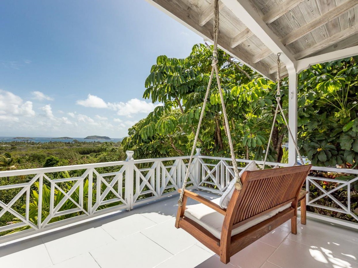 Balcony with sofa swing overlooking the countryside and coastline