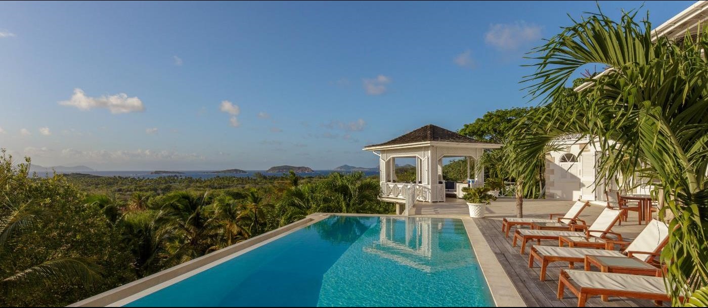 Pool area with loungers at Callaloo and garden views 