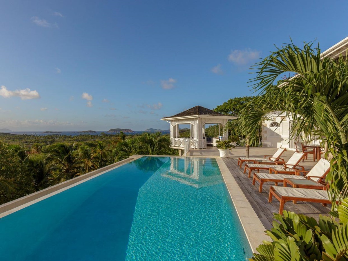 Pool area with loungers at Callaloo and garden views