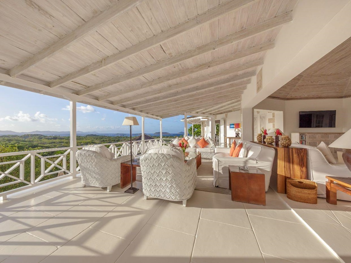 Covered terrace with seating area and panoramic views at Callaloo