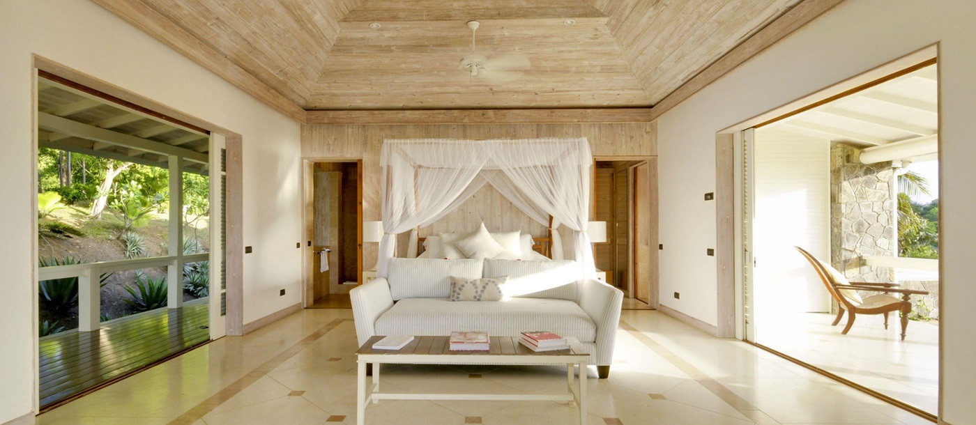 Double bedroom with terrae and balcony access at Full Moon, Mustique