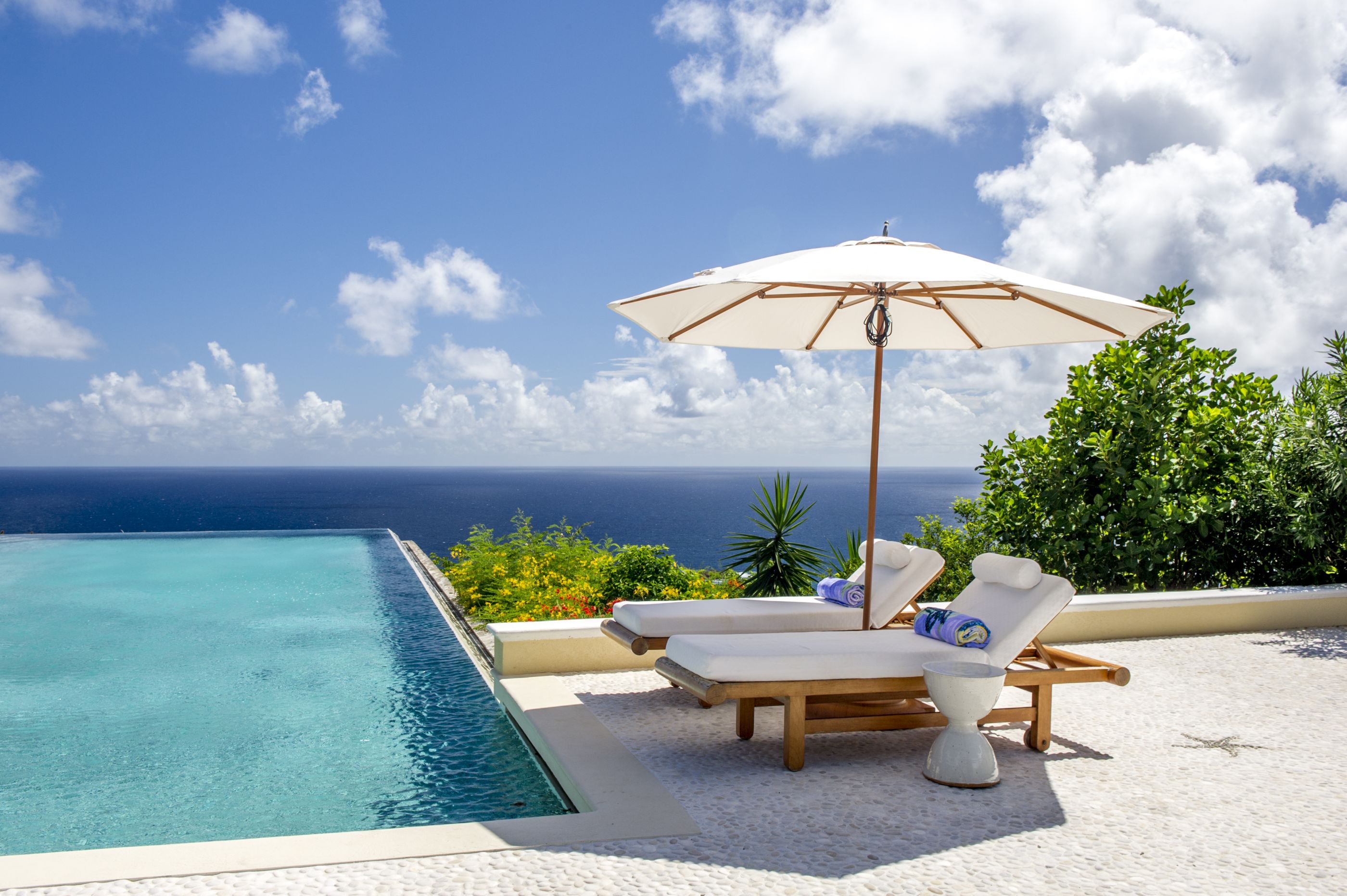 Sunbeds at the swimming pool of Ocean Breeze, Mustique
