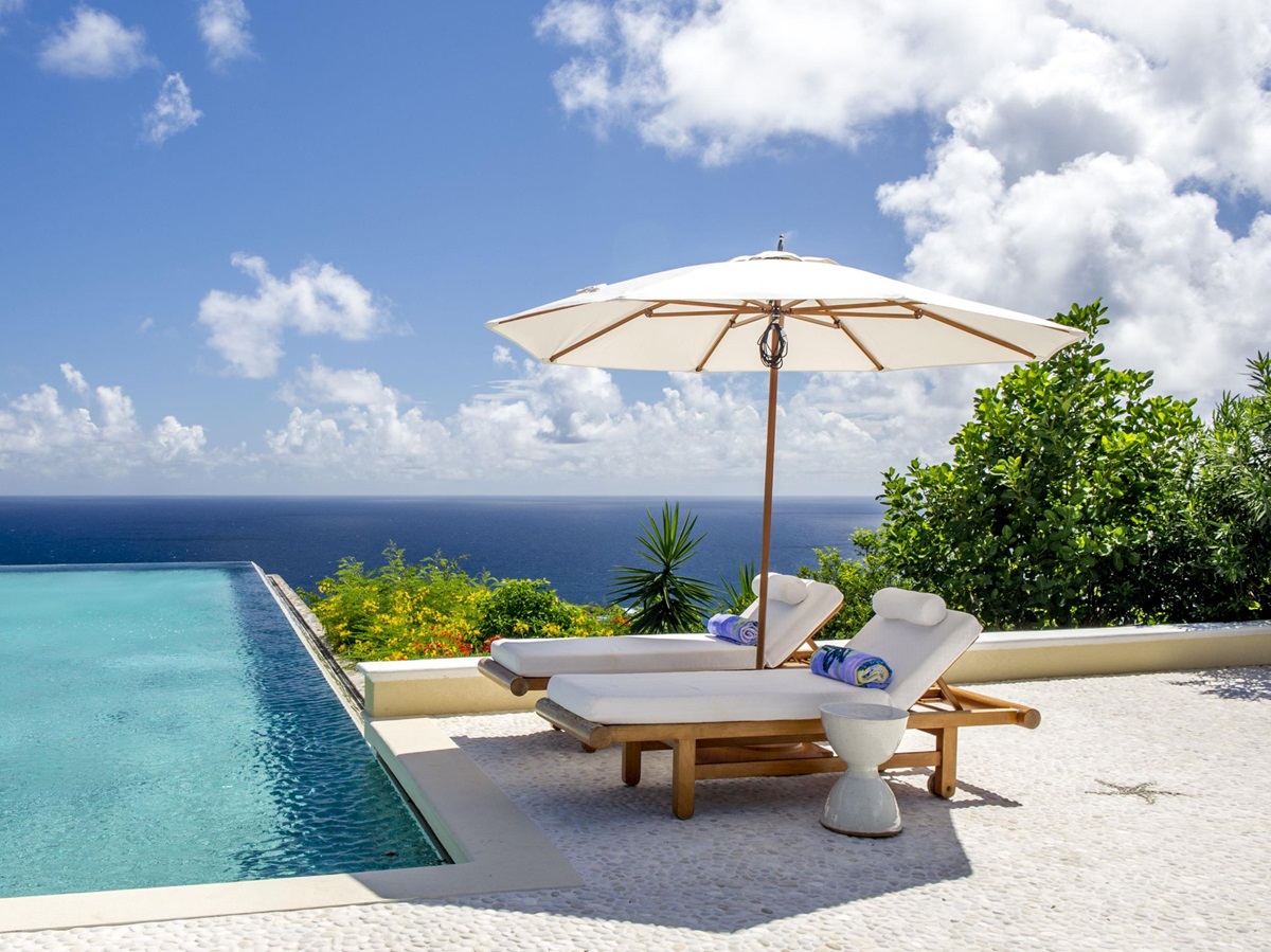 Sunbeds at the swimming pool of Ocean Breeze, Mustique