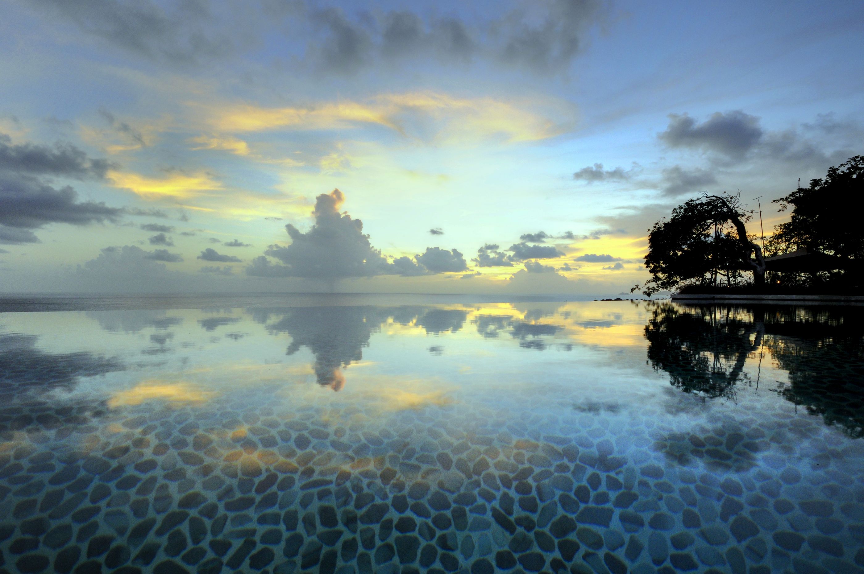 Evening view and reflectin into the swimming pool of Opium, Mustique