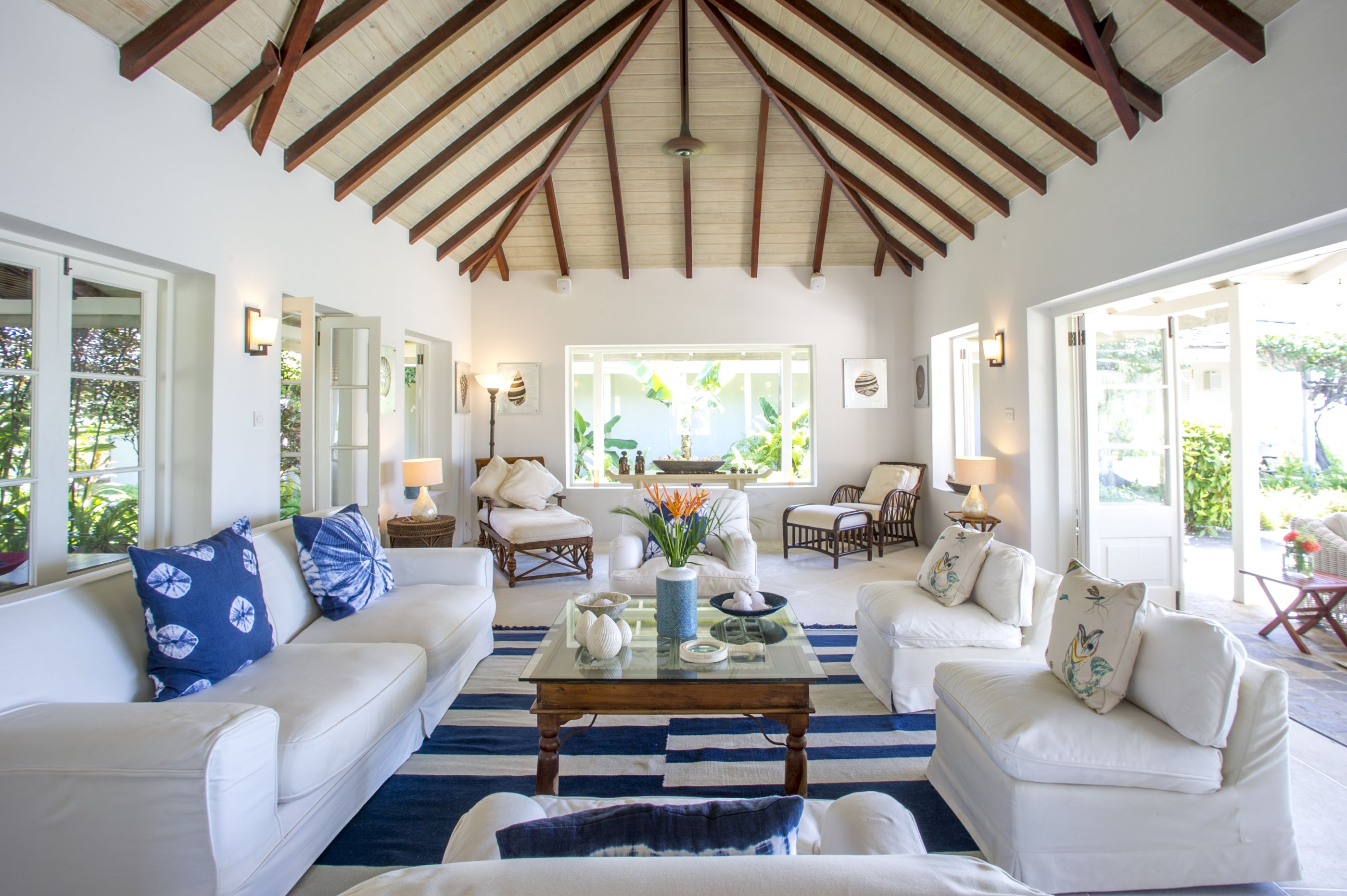 Living area with white sofas and table at villa Pangolin in Mustique