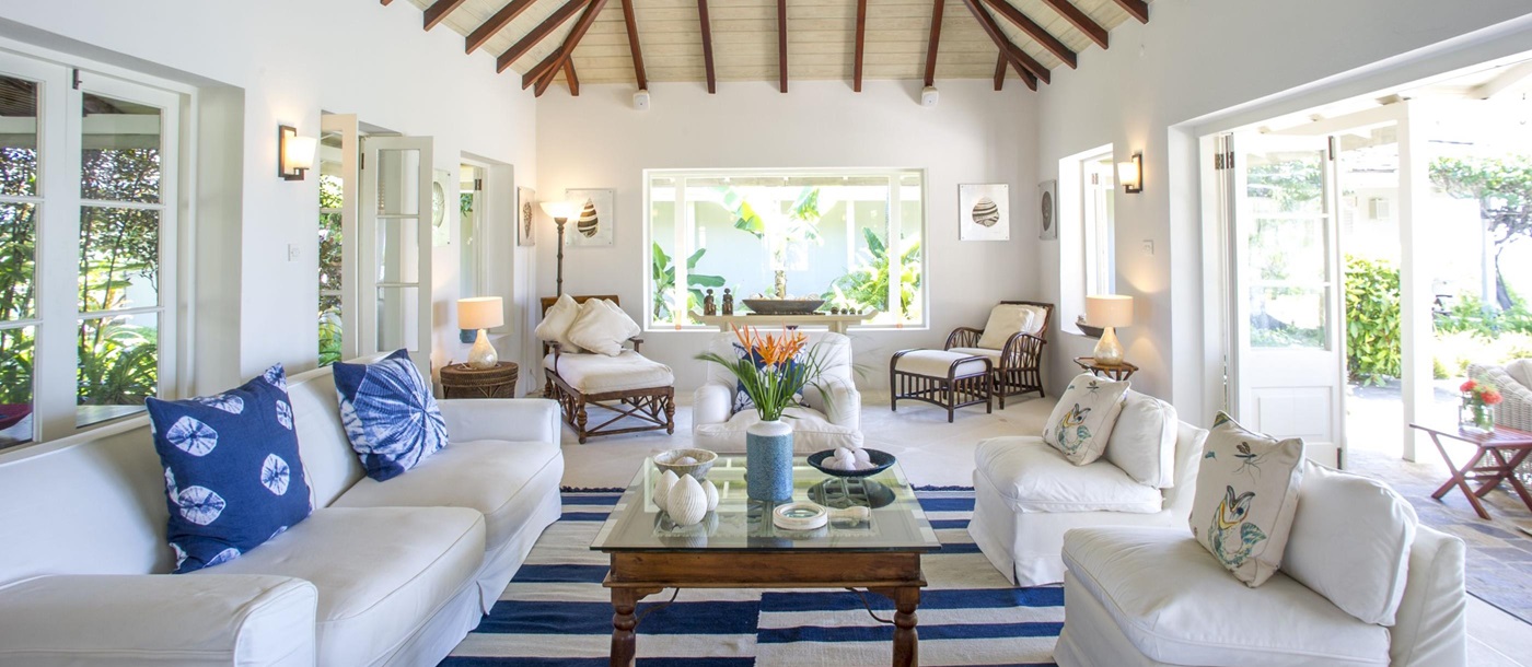 Living area with white sofas and table at villa Pangolin in Mustique