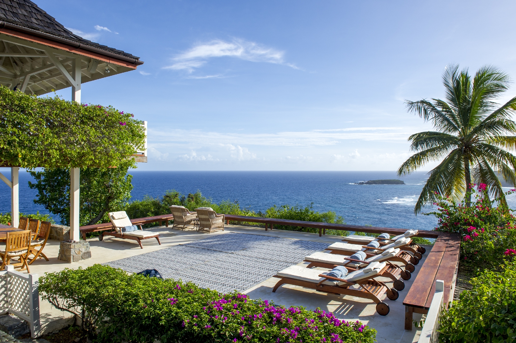 Terrace with sun loungers at Pangolin, Mustique