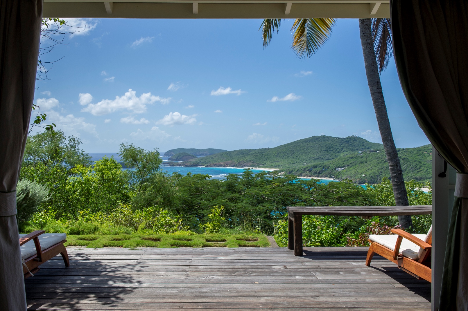a terrace with ocean view at villa Pangolin in Mustique
