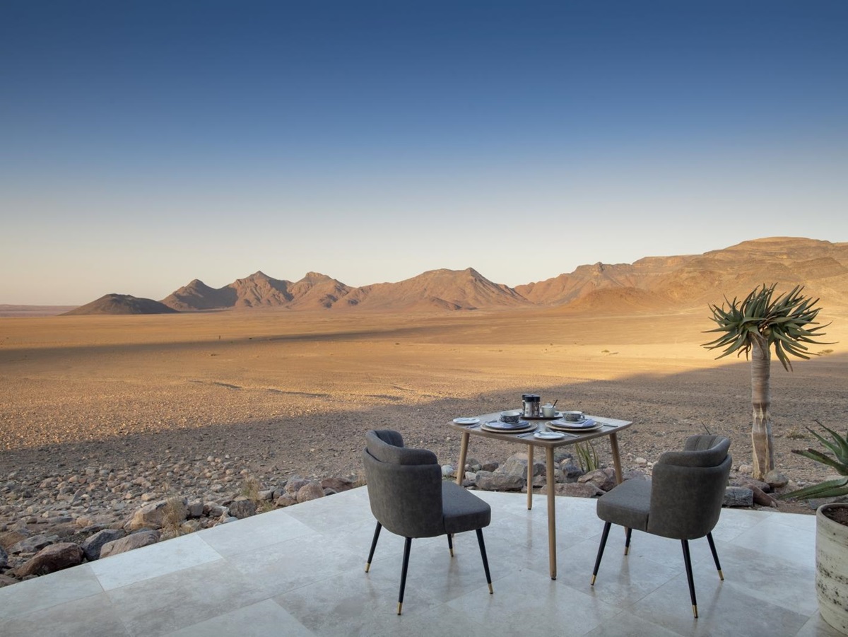 Table set up for breakfast on the veranda overlooking the vast emptiness of the desert