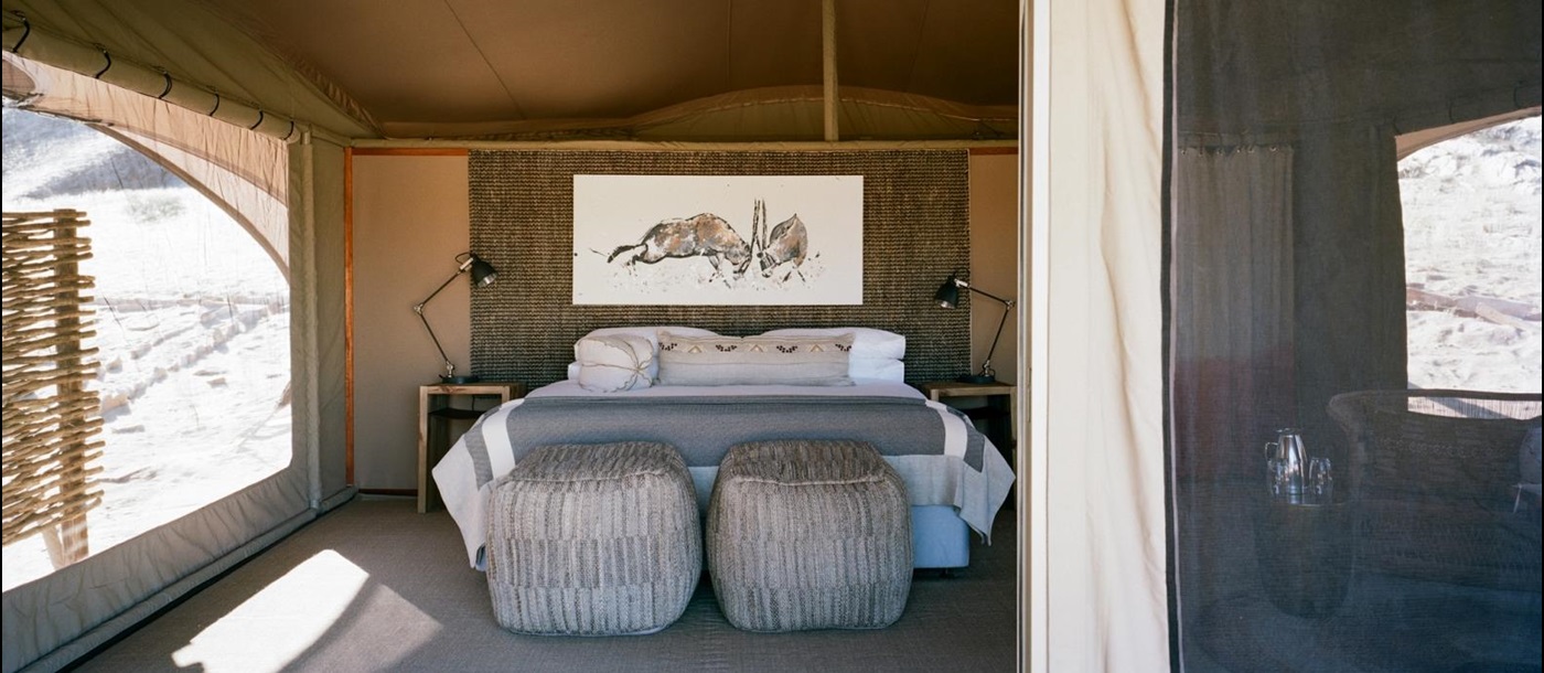 Tented bedroom with animal drawing over bed